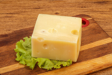 Emmental cheese over wooden board