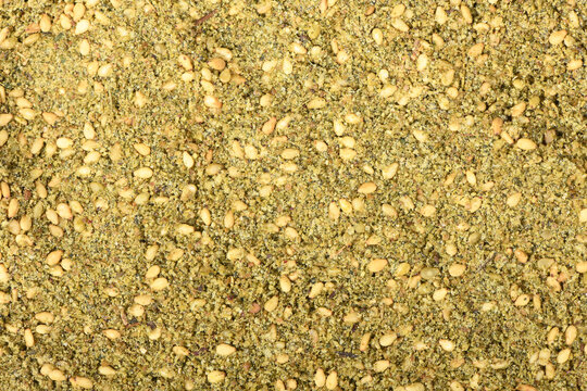 Za'atar (zatar), blend of herbs, sesame seeds and salt in pile, top view.