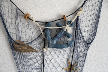 Composition from the fishing net on the wall of the house