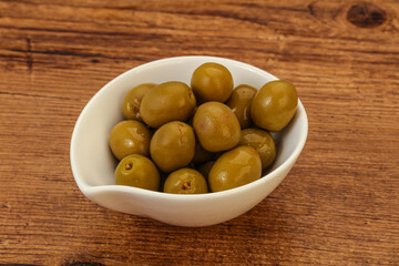 Green pickled olives in the bowl