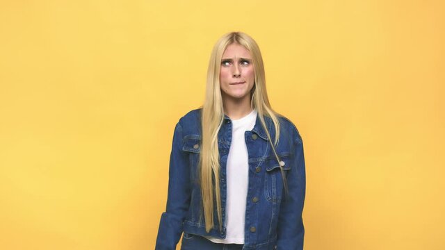Young caucasian blonde woman confused, feels doubtful and unsure