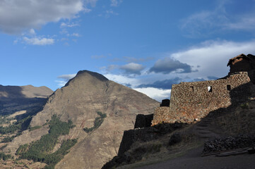Fototapeta na wymiar Stone ruins on a hilltop in the Sacred Valley of Peru on a cloudy day