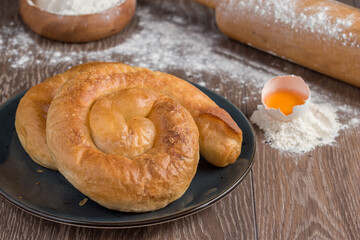 Traditional Turkish Borek or Turkish pastry with minced meat, cheese and spinac on wooden background