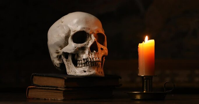 Still life type a scene with human skull and candle