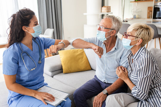 Female nurse greeting with seniors patients with mask while being in a home visit.