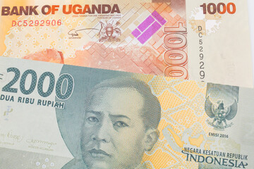 A macro image of a grey two thousand Indonesian rupiah bank note paired up with a orange and white...