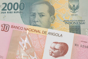 Fototapeta premium A macro image of a grey two thousand Indonesian rupiah bank note paired up with a colorful ten kwanza bank note from Angola. Shot close up in macro.