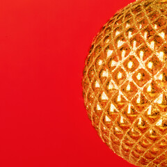 Abstract golden glowing halfsphere on red background.