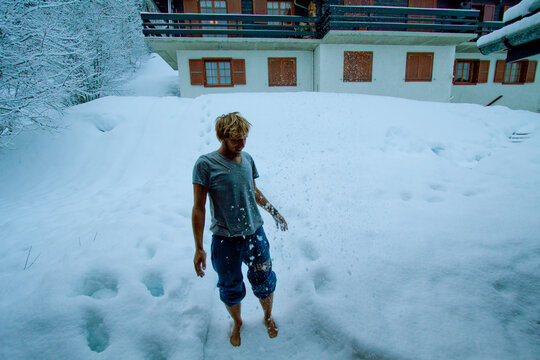 A young man playing in the snow.