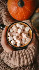 Cup of coffee with marshmallows on hand