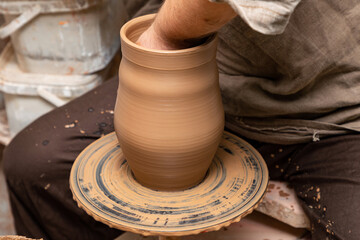 Creating a pot of clay close-up. Hands making products from clay. Potter at work.