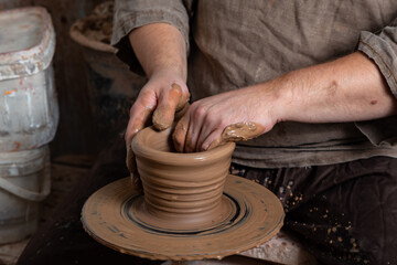 Creating a pot of clay close-up. Hands making products from clay. Potter at work.