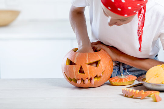 Unusual funny image of a woman with a pumpkin. Celebration of halloween 2020 with medical mask concept