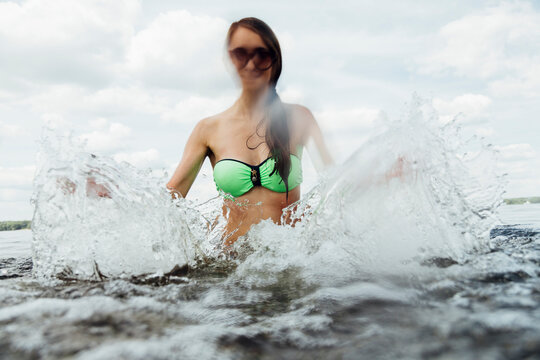 happy young woman enjoy water splashes