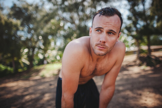 Healthy young shirtless man recovering after hard workout