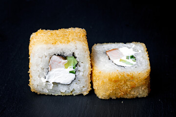 sushi rolls on a black background
