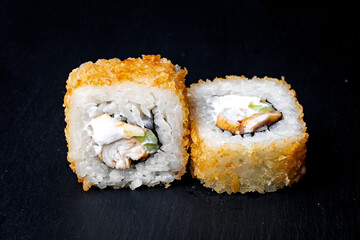 sushi rolls on a black background