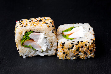 sushi rolls on a black background