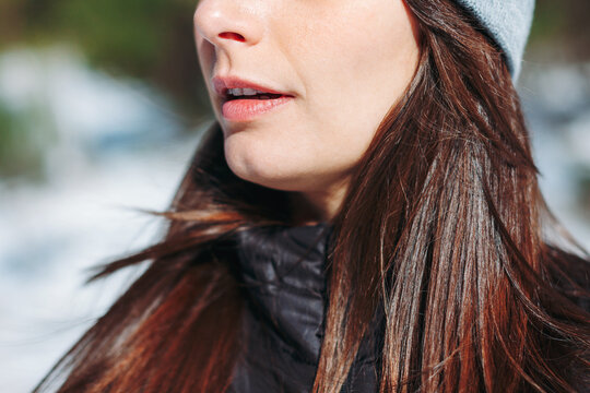Closeup of a young woman on a cold snowy day.