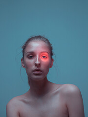 Female with perfect healthy skin and pink neon light spot on eye. Ad poster for skincare cosmetics