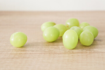 Ripe sweet grapes on wooden background