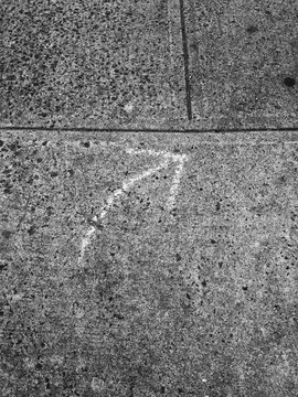 Arrow drawn on sidewalk