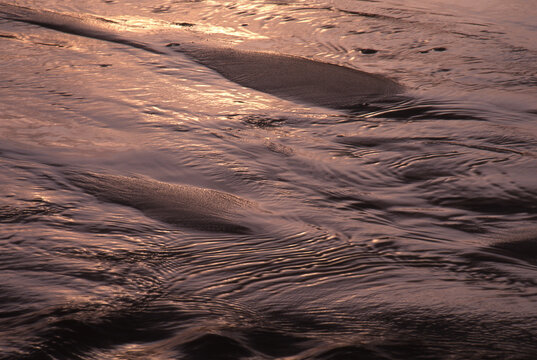 tidal wave water patterns in wet sand on Pacific Coast