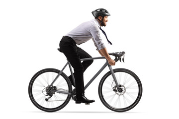 Profile shot of a businessman riding a bicycle with a helmet