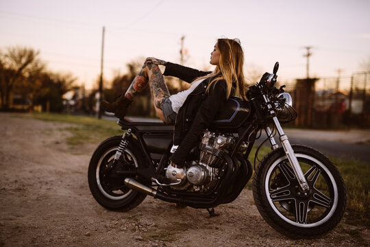 Attractive girl motorcycle rider posing