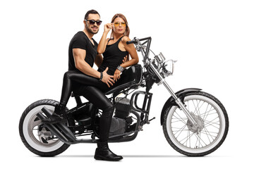 Plakat Young man and woman sitting on a chopper motorbike in an attractive pose
