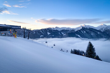 Fototapeta na wymiar Arrival of Schönleiten cable car ski lift in the region of Saalbach-Hinterglemm early in the morning.