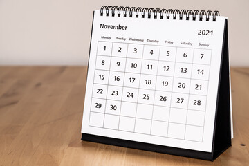 Fototapeta Month page: November in 2021 paper calendar on the wooden table obraz