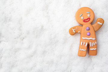 Top view of gingerman on snowy background with copy space