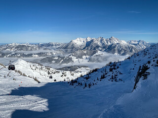 Fototapeta premium Scenic view Lofer Mountains and ski slopes of Fieberbrunn, Austria against blue sky.