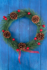 Christmas wreath on blue wooden background