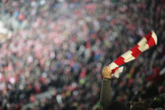 soccer stadium fan hand red white scarf