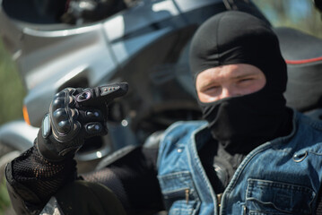 Fototapeta na wymiar A motor biker is showing a middle finger close up.
