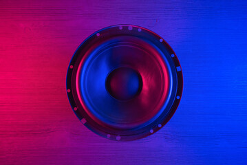 A car audio loudspeaker on the table in the neon lights.