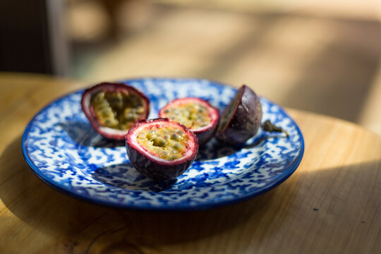 Delicious Passion Fruit Cut In Half On Blue Plate