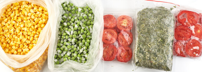 Set of frozen food packed in bags. Store vegetables for the winter, top view. Tomato, green peas,...