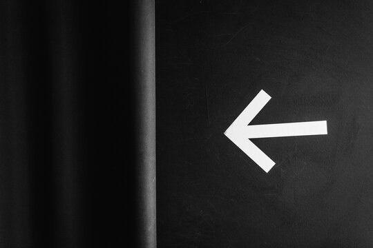 Directional arrow sign on wall
