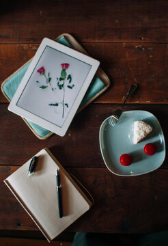 Notebook, cake and notebook on the table