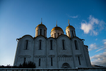 old white-stone temples against the backdrop of sunset