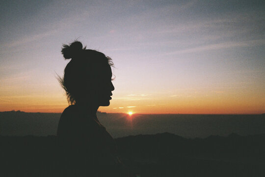 Silhouette of woman in sunset