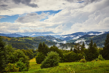View from the Synevyr pass to the foggy mountains in National Natural Park Synevir, Mizhhirya district of the Transcarpathian region, Ukraine