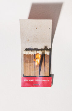 Lit Match Burning In Matchbook
