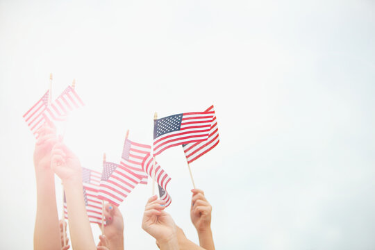 Flag: Group of Hands Holding Flags - Powered by Adobe