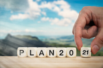 Hand bringing dice to make the expression 