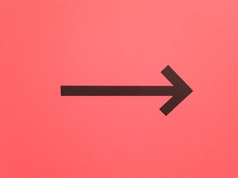 Black arrow on pink background