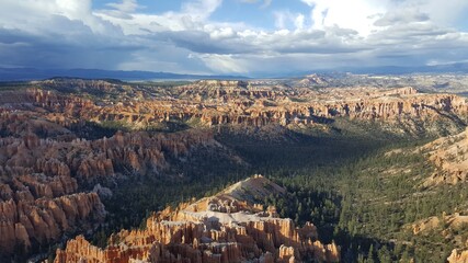 Panoramic view of yellow and orange sandstone formation with sun and shade highlights. ..Bryce...
